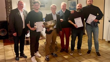 Das Foto zeigt den Präsidenten des Segelclub Edersee Guido Kalbe (links), den Präsidenten des Hessischen Seglerverbandes, Klaus-Dieter Lachmann (Mitte) und den Sieger Björn Geisler mit seiner Crew (v.l.n.r) Mattis Blum (ESV), Julian Leschinsky (SCAS) und Philipp Behrendt (ESV). Es fehlt Cedric Stiel (ESV).                Bild: Johannes Brack, Sportwart Segelclub Edersee e.V.